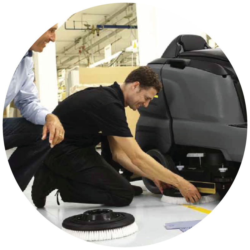 A technician repairing floor scrubber