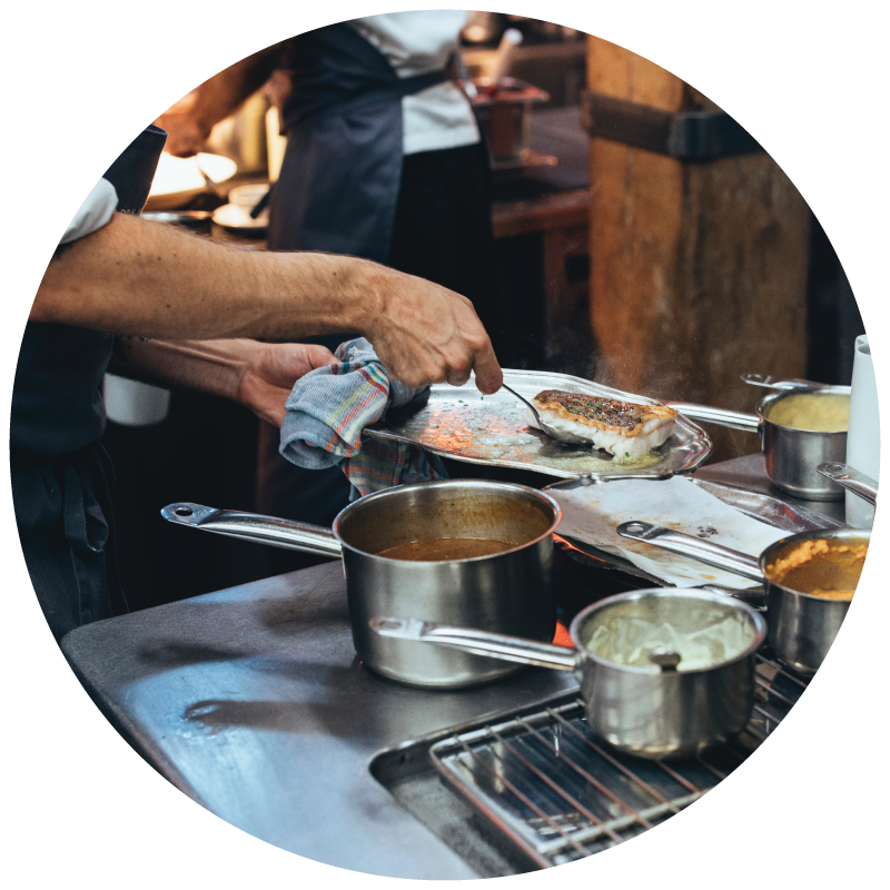 A chef cooking in a commercial kitchen