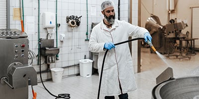 A packer process worker cleaning equipment- chemistry