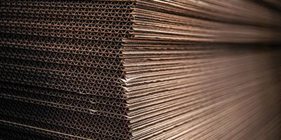 a stack of corrugated boxes flattened - sustainable packaging product solutions