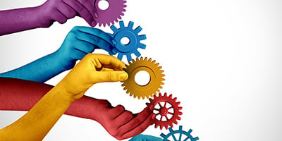 hands in different color holding different types of gears