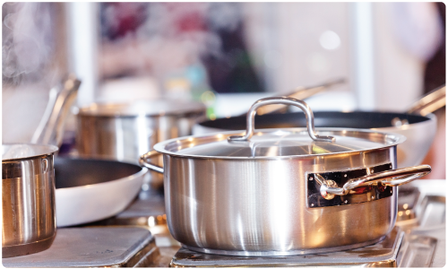 Clean and shiny commercial kitchen pots and pans in foodservice