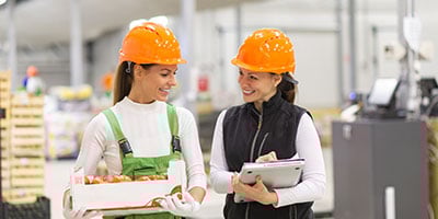 Evaluate - two supervisers evaluating food packing process