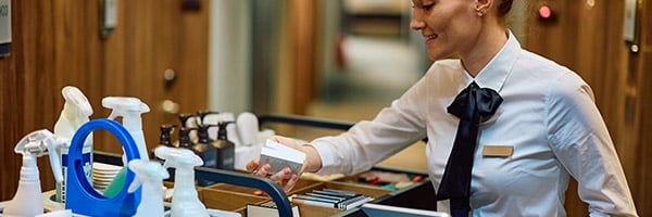 house keeping staff evaluating cleaning cart at a hotel