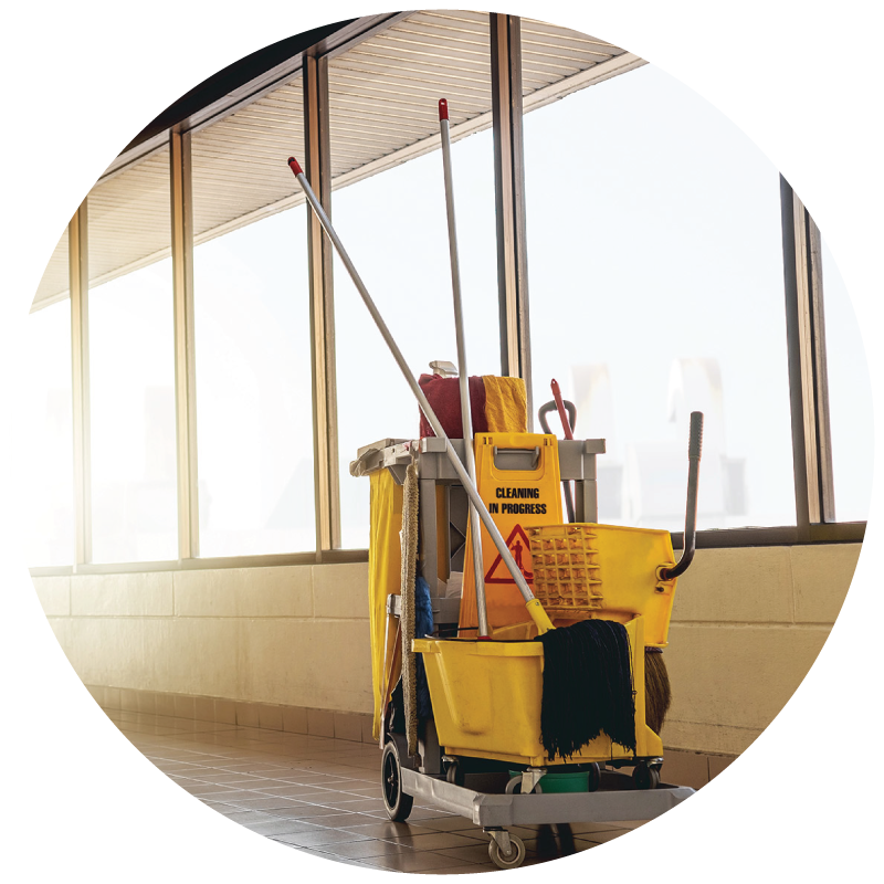 An image of cleaning cart in a commercial building hall way