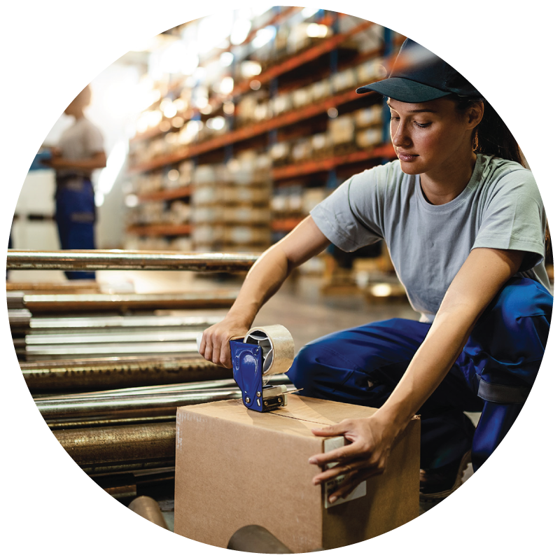 A warehouse worker taping a box for shipping in distribution center