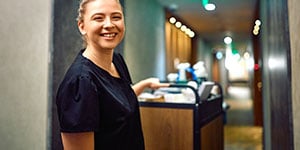housekeeping cleaning cart with staff