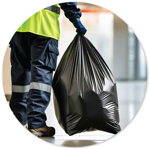 a facility manager holding a filled trash liner