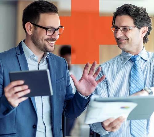 two businessmen looking at a report and discussing business