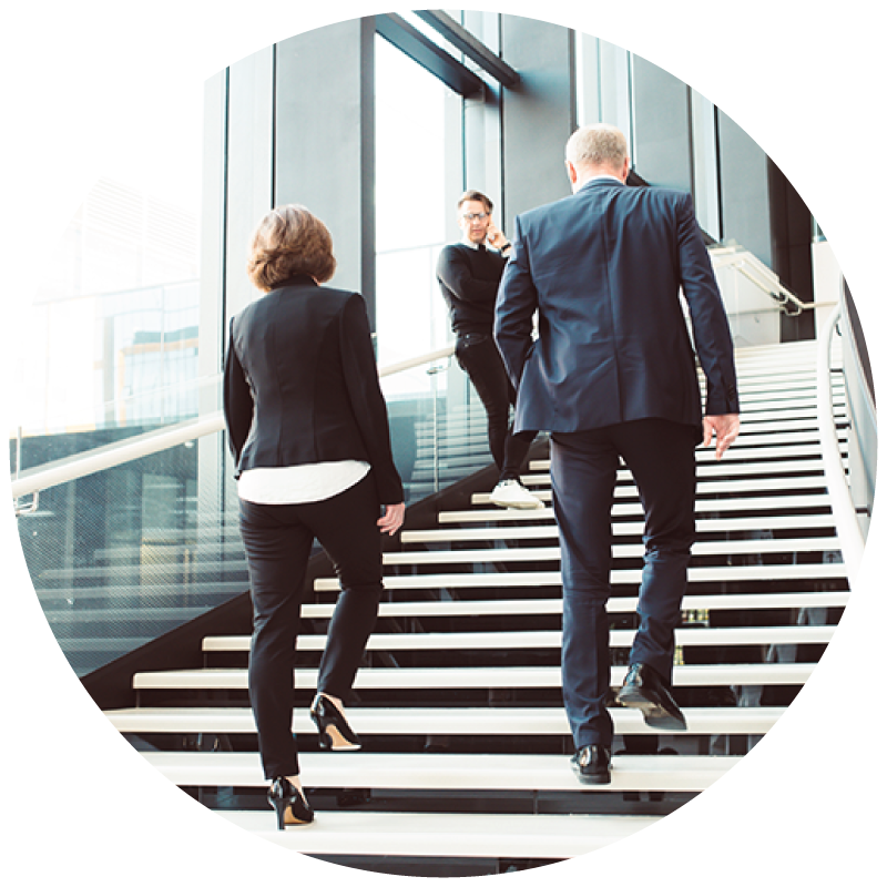 A couple of business people walking up the stairs in a commercial building