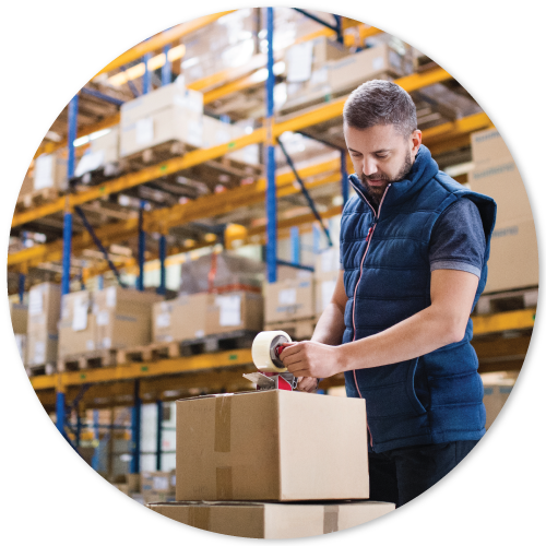 a warehouse worker sealing packaging box