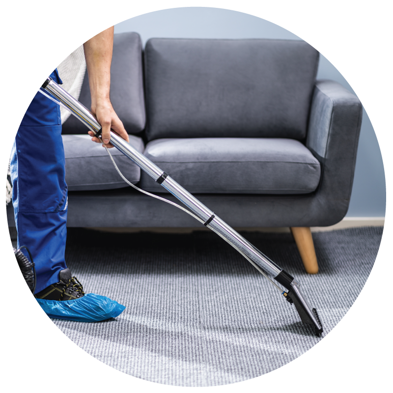 A janitor vacuuming the floor