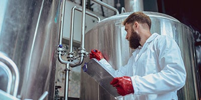 Technician servicing packer processing equipment