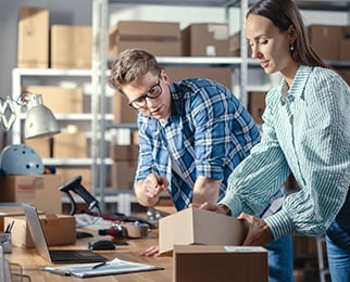 retail shipping staff working on shipment using various shipping supplies