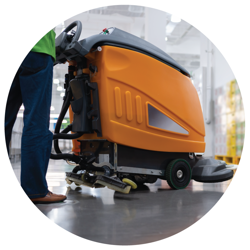 A custodian operating floor scrubber machine