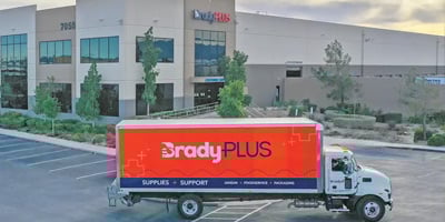 Semi wrapped with BradyPLUS brand parked in front of BradyPLUS facility