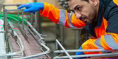 technician looking at equipment for service