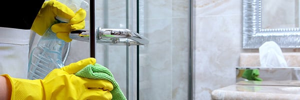 house keeping using green cleaning solution to clean the guest room