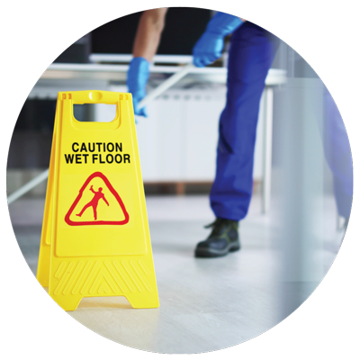 a janitor mopping the floor with yellow wet floor caution sign