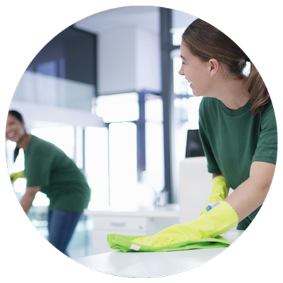 two custodial workers conversing while cleaning