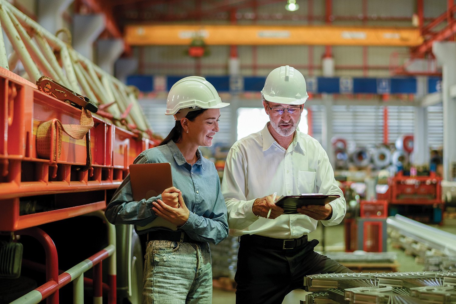 Two people wearing hard hat in the plant