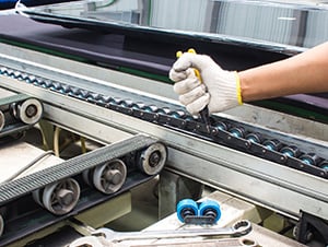 a technician repairing packaging conveyor belt
