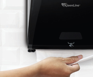 A person dispensing a papertowel from a dispenser