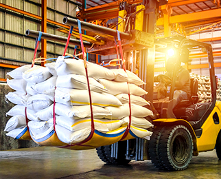 FIBC bags carried on a forklift in a warehouse - packaging supplies