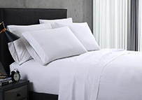 fresh and clean bed sheets on  hotel guestroom bed