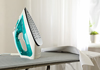 an iron on the iron board in a hotel room - small appliances