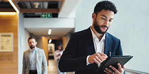 a man looking at his tablet to check operational cost