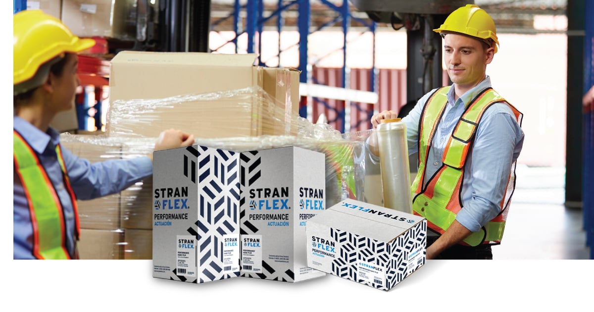 A warehouse associate stretch wrapping a pallet with STRANFLEX boxes in the front of an image