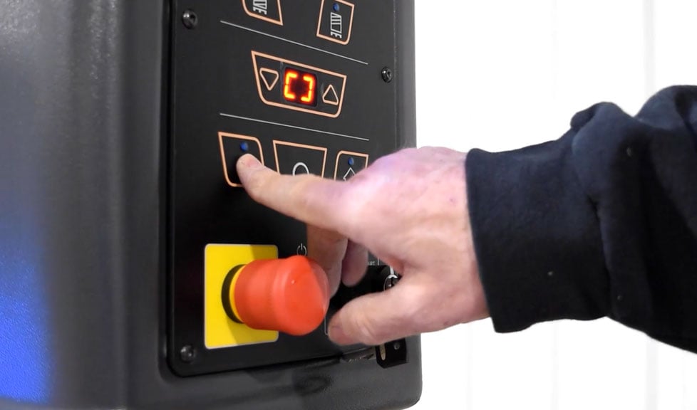 a person using packaging equipment control panel